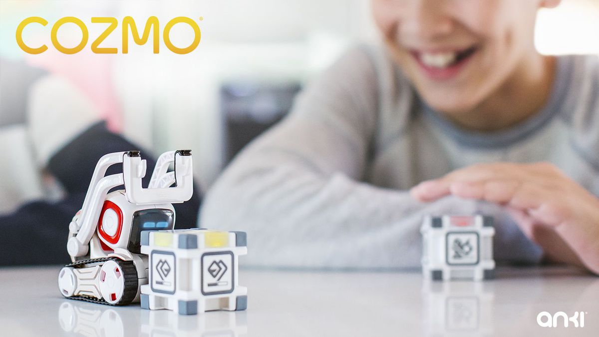 Boy watching Cozmo with blocks